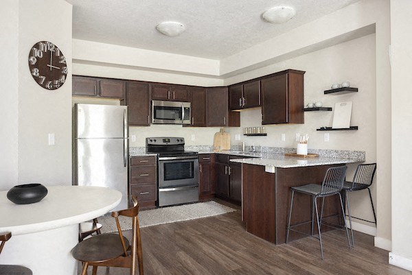 a kitchen with a refrigerator freezer and a stove top oven