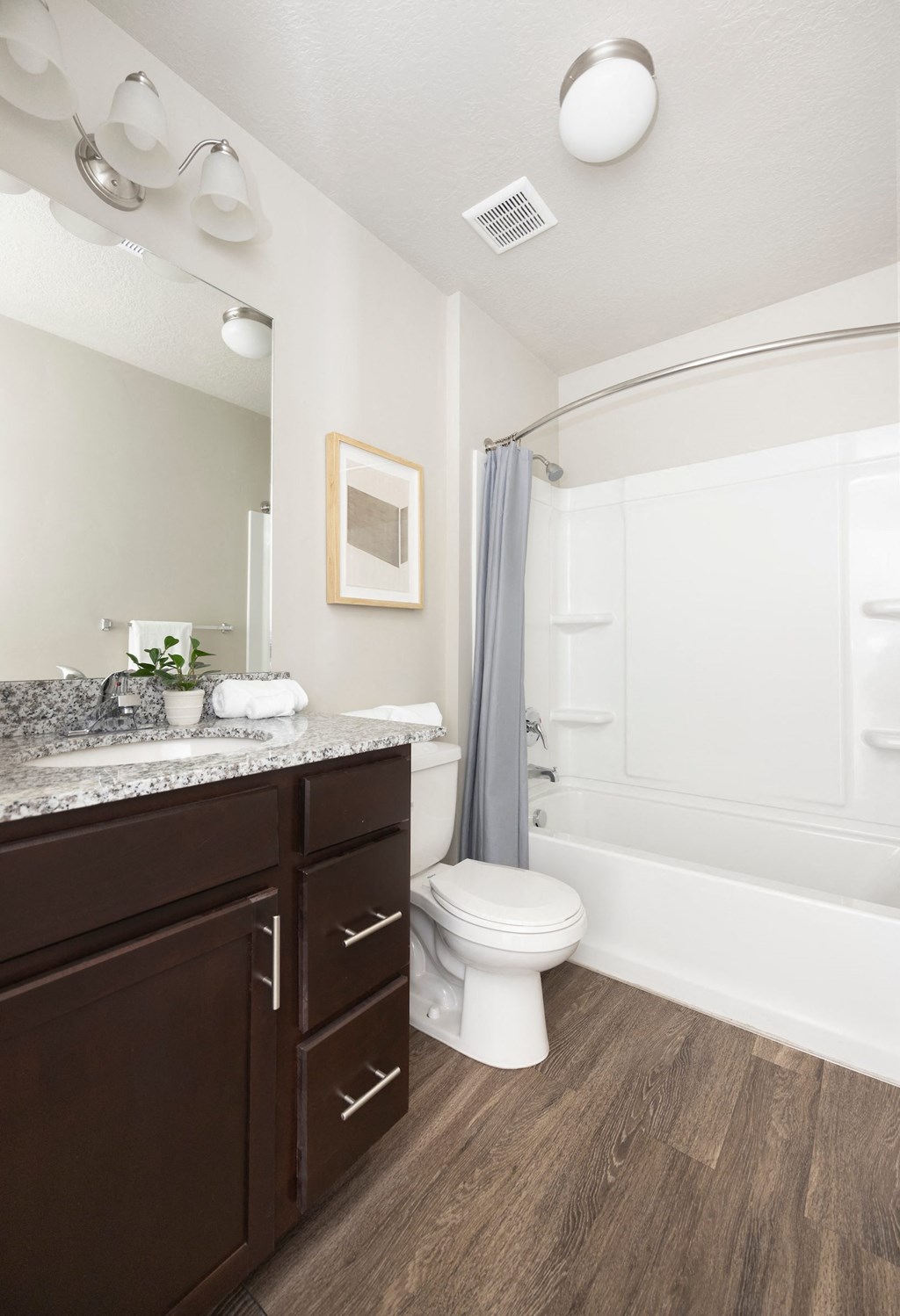 a bathroom with a toilet sink and bathtub in a 555 waverly unit