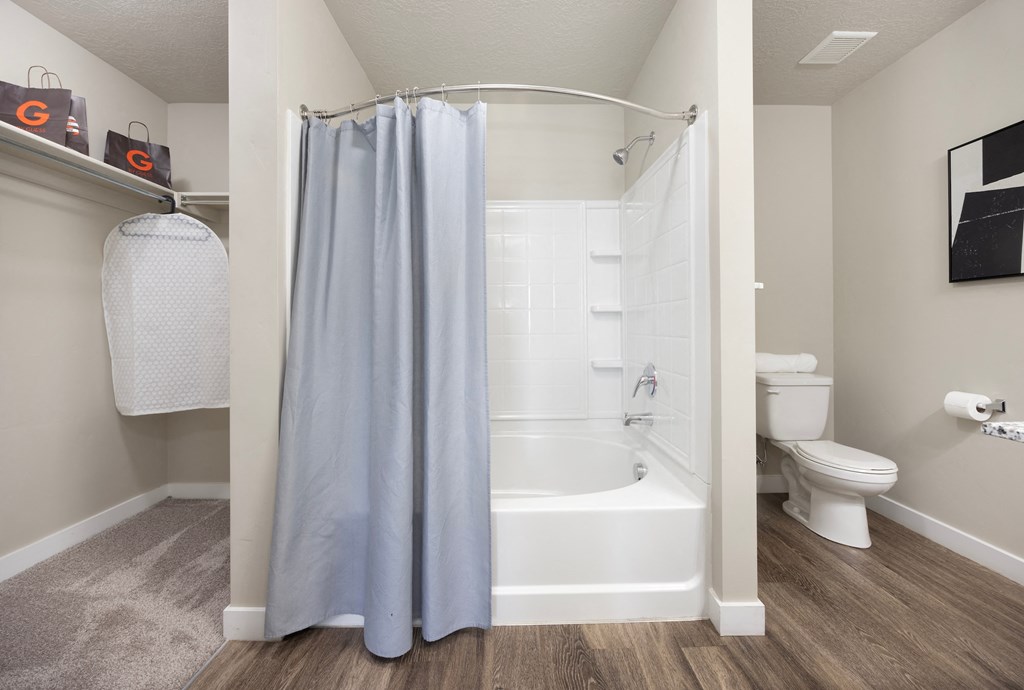 a bathroom with a bathtub and a toilet in a 555 waverly unit