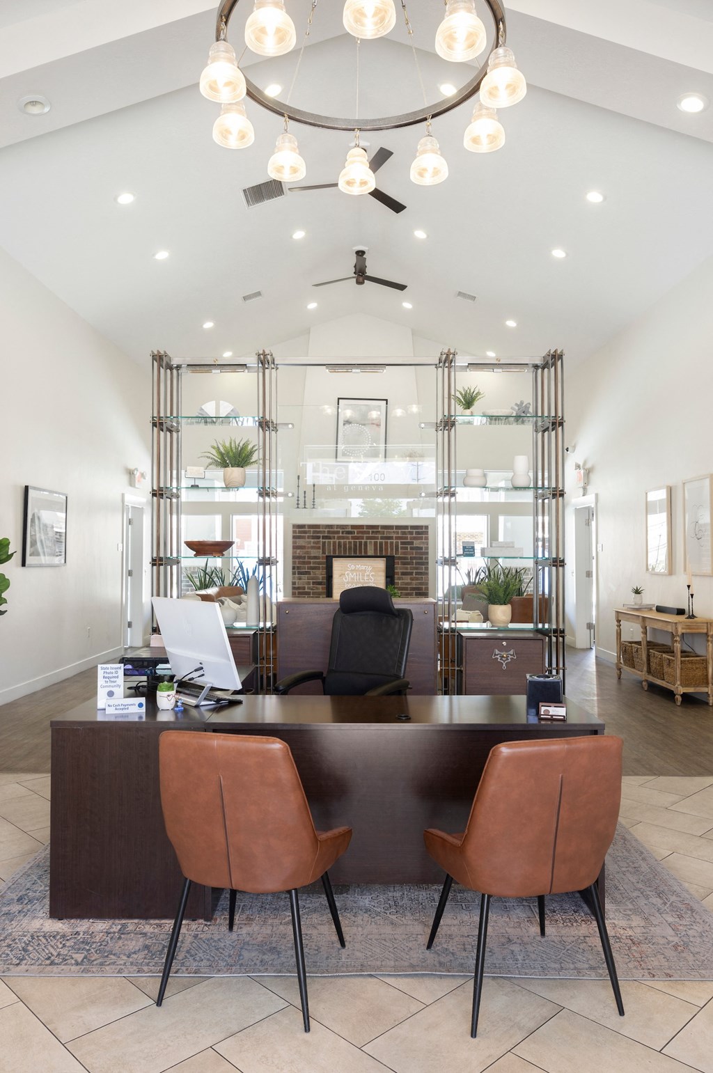 a view of the reception desk with a fireplace in the background and a living room in the