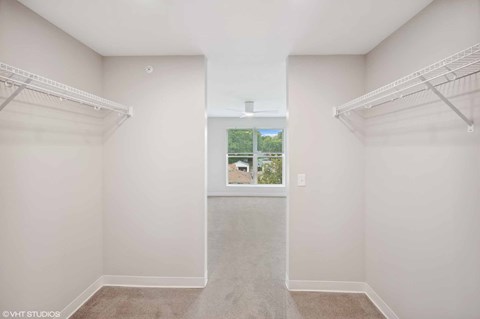Empty bedroom with white walls and a window.