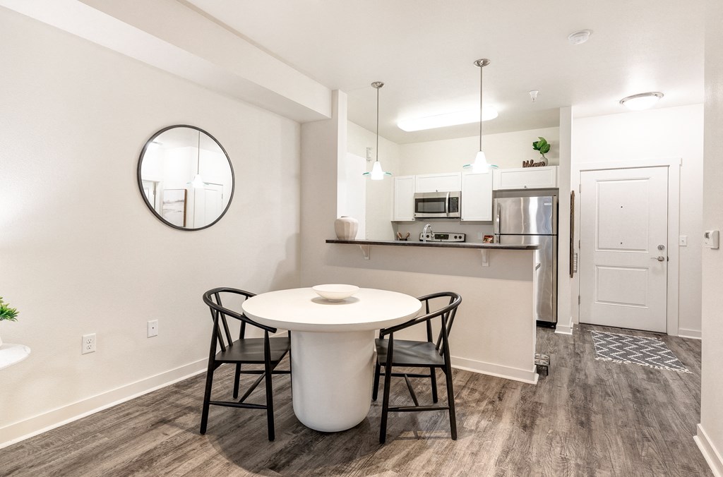 a kitchen and dining room with a white table and chairs