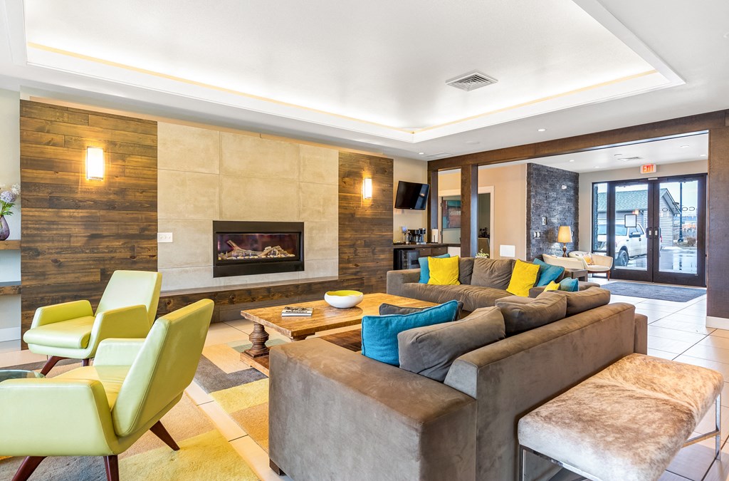 a living room with couches and chairs and a fireplace