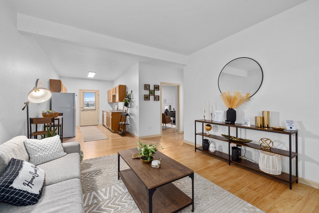 A living room with a grey sofa and a wooden coffee table.