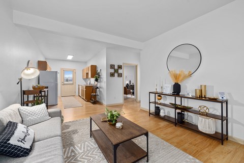 A living room with a grey sofa and a wooden coffee table.