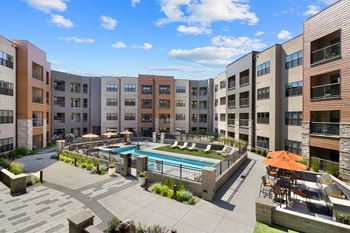 a large pool is in the middle of a building with apartments at Avenue C Apartments, Billings, MT, 59102