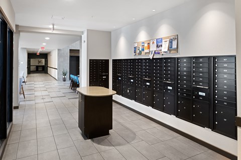 a long hallway with lockers and a table in the center at Avenue C Apartments, Montana