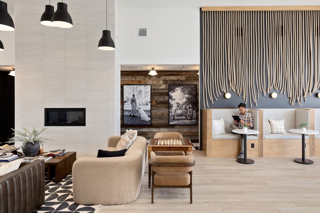 a man working on a laptop in a hotel lobby