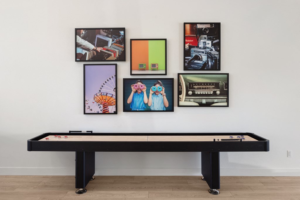 a wall with pictures and a pool table