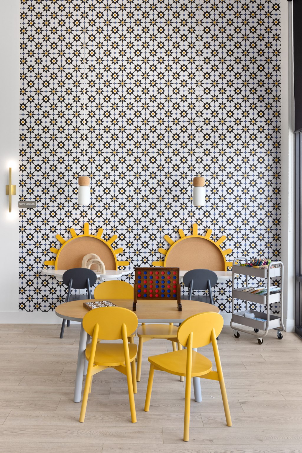 a room with a table and chairs and a wall with a geometric pattern