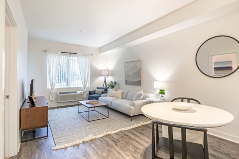 a living room with a couch and a table and a tv at Corso Apartments, Missoula, MT