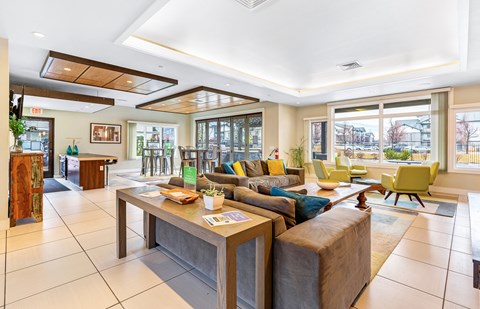 a living room with couches and chairs and a table at Corso Apartments, Missoula, MT