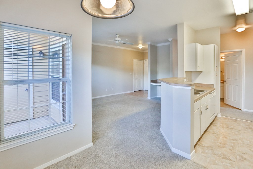 a kitchen and living room with a large window
