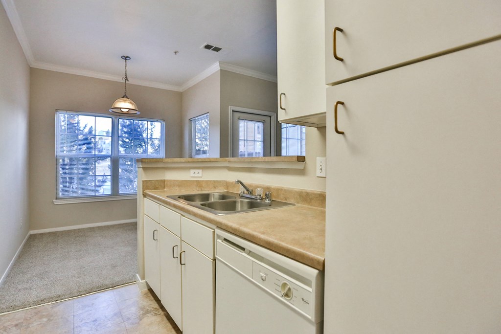 a kitchen with white cabinets and a sink