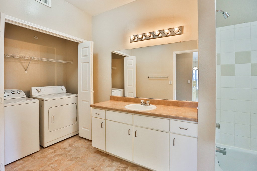 a bathroom with a sink and a washer and dryer