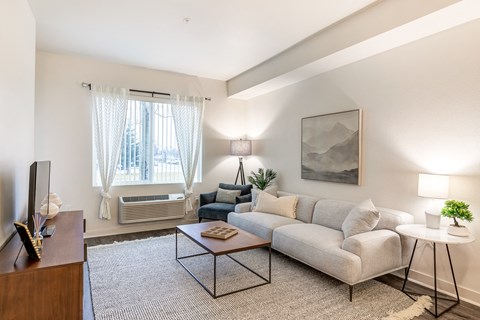 a living room with a couch and a coffee table at Corso Apartments, Missoula, MT