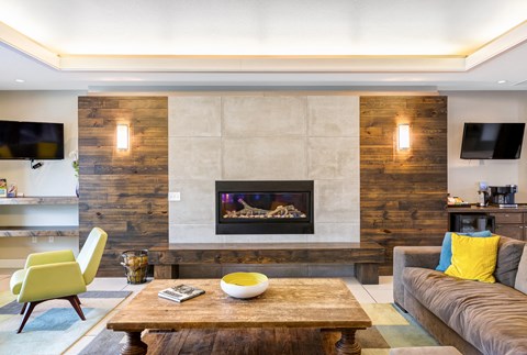 a living room with a fireplace and a coffee table at Corso Apartments, Missoula, MT