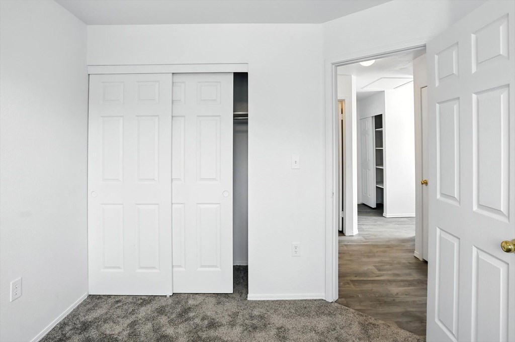 A white door is open to a hallway. at Oakstone Apartments, Clearfield