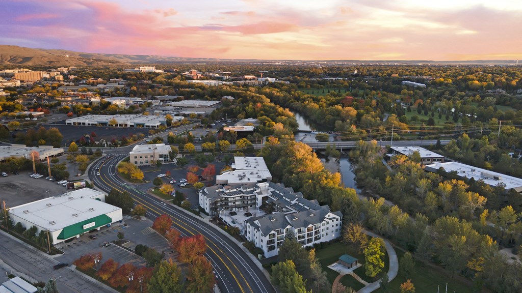 an aerial view of a city with a river and buildings