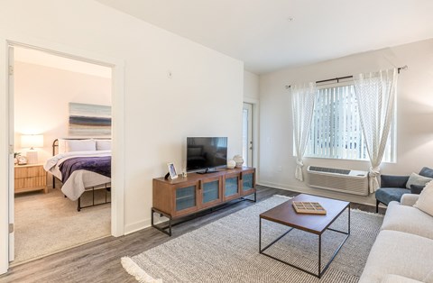 a living room with a couch and a coffee table and a tv at Corso Apartments, Missoula, MT