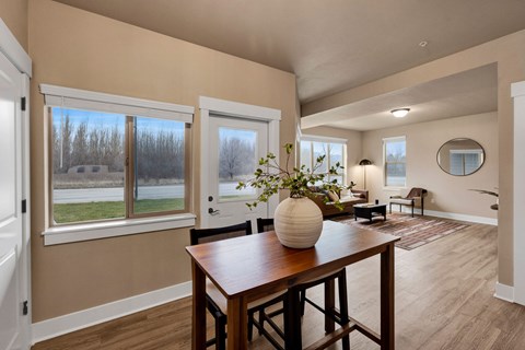 A dining room with a wooden table and chairs at Brooklyn West Apartments, Missoula, 59808