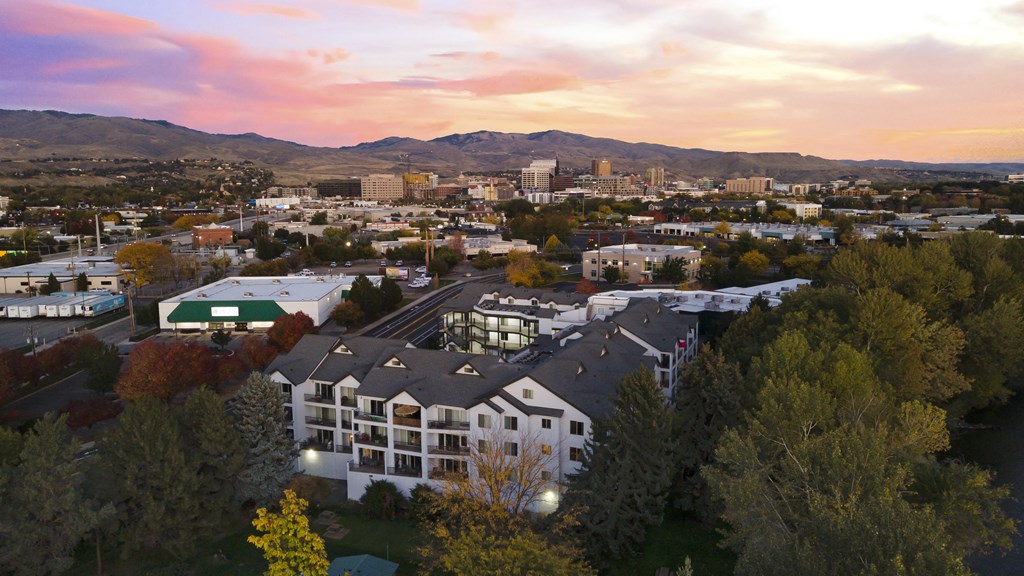 an aerial view of a building with a city in the background