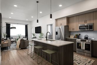 an open concept kitchen and living room with a large island  at Altair, Meridian