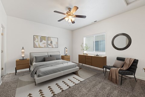 A bedroom with a bed, chair, and a rug. at Verraso Village Apartments, Meridian 83646