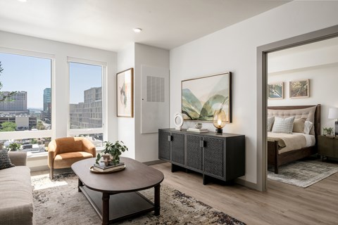 A modern living room with a large window overlooking the city.