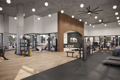 A gym with a variety of equipment and people working out.