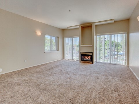 A spacious living room with a fireplace and sliding glass doors.