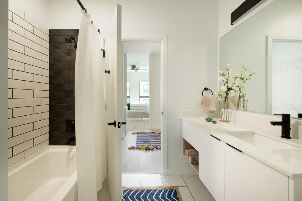a bathroom with a white sink and a white bathtub