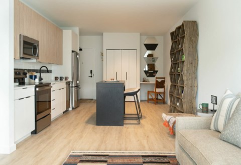 a living room with a kitchen and a table