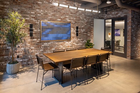 A conference room with a long table and chairs.