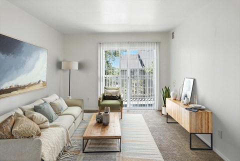 A living room with a couch, a coffee table, and a painting on the wall.