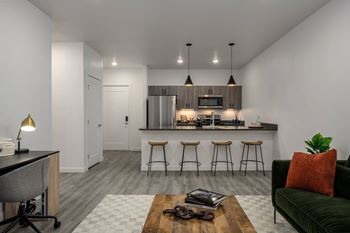 an open kitchen with a bar and a living room