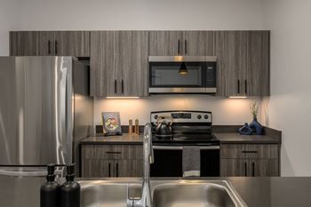 a kitchen with stainless steel appliances and wooden cabinets