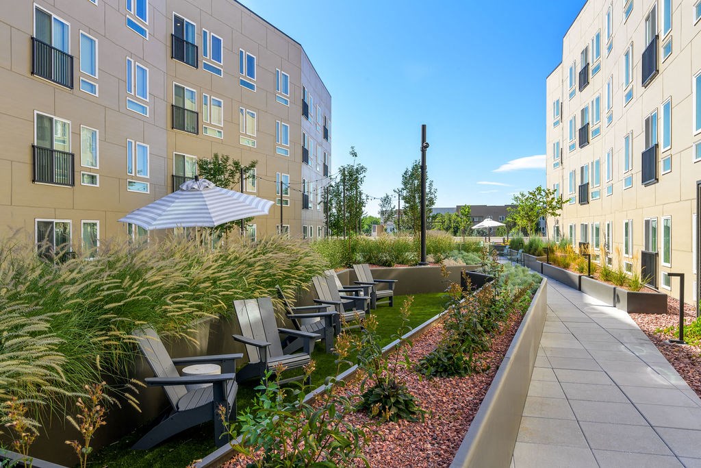 an outdoor seating area with chairs in front of a building at Crosshatch, Garden City, 83714
