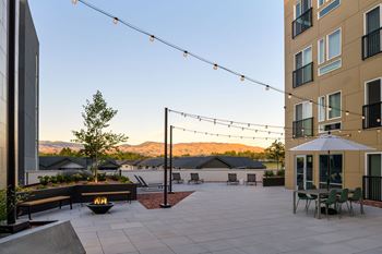 a patio with a fire pit in a courtyard