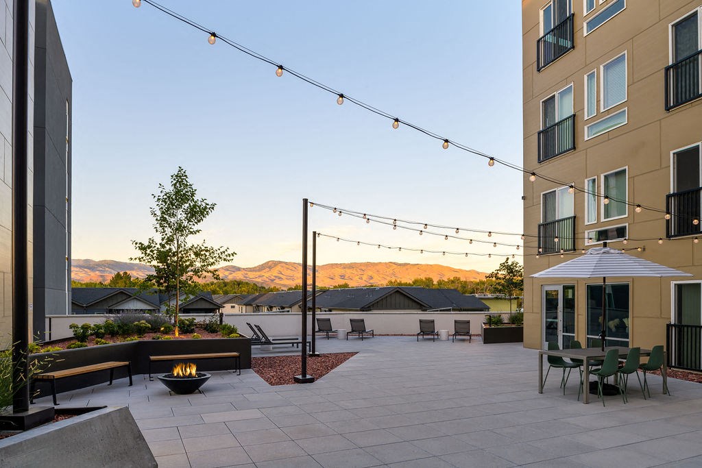 a patio with a fire pit in a courtyard at Crosshatch, Idaho, 83714