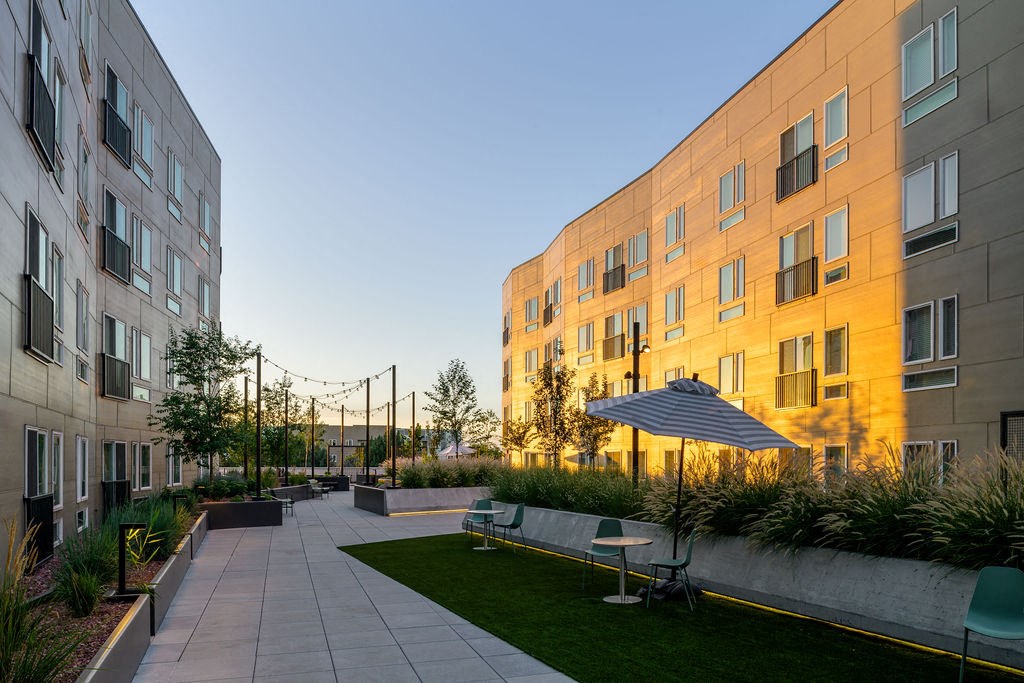 a courtyard with an umbrella in front of a building at Crosshatch, Garden City, ID, 83714
