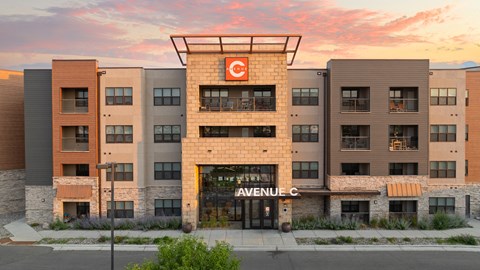 an exterior view of anaweel cc building at sunset at Avenue C Apartments, Billings, 59102