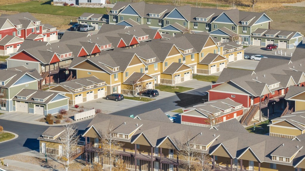 A suburban neighborhood with houses and cars.