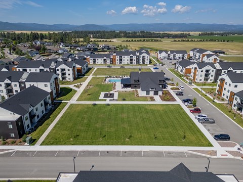 A large grassy area in front of apartment buildings. at Silverbrook Apartments, Kalispell, Montana