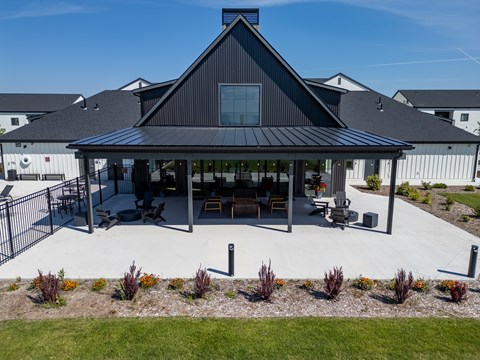 A black house with a white fence and a green lawn. at Silverbrook Apartments, Kalispell, MT