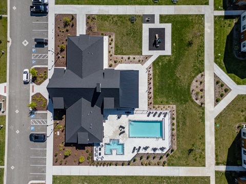 A large building with a pool in front of it. at Silverbrook Apartments, Kalispell