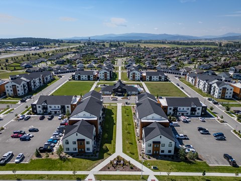 A bird's eye view of a residential area with houses and cars. at Silverbrook Apartments, Montana