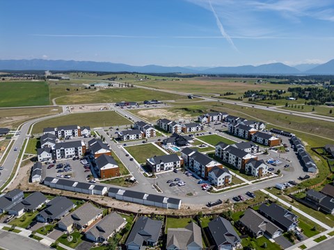 A bird's eye view of a residential area with houses and a parking lot. at Silverbrook Apartments, Kalispell, MT, 59901