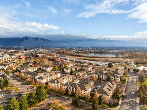 A view of a residential area with apartment buildings and a mountain in the distance.