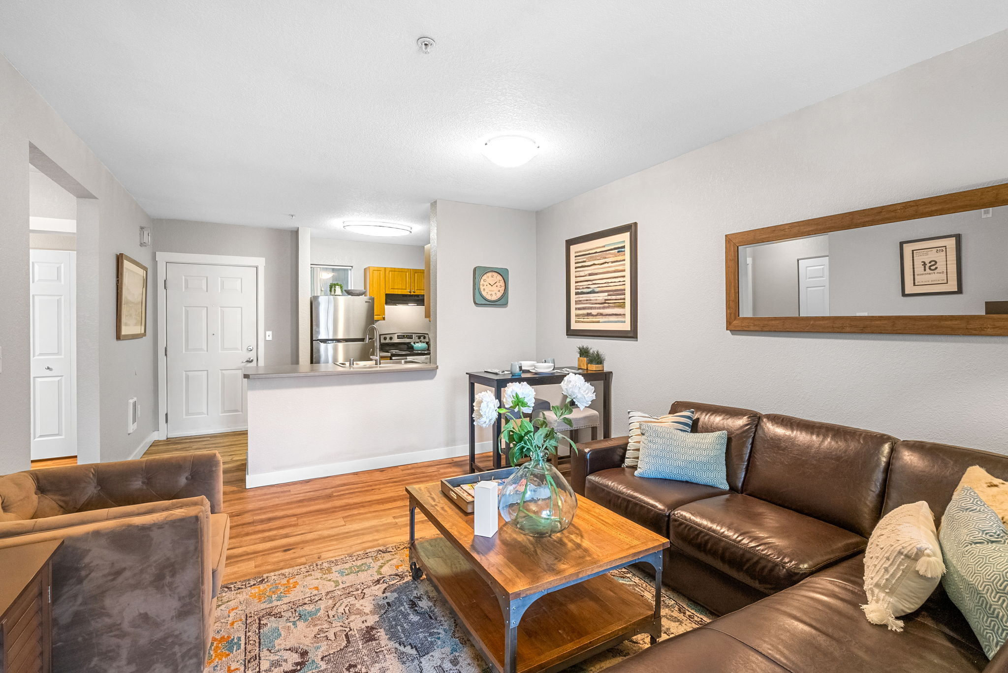A living room with a brown couch and a wooden coffee table.